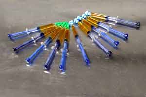 10 syringes on metal table