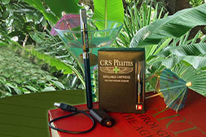 CRS Pharms box, e-pen, art book, martini stemware and umbrella  on table