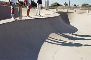 edge of skateboard ramp with waiting skaters